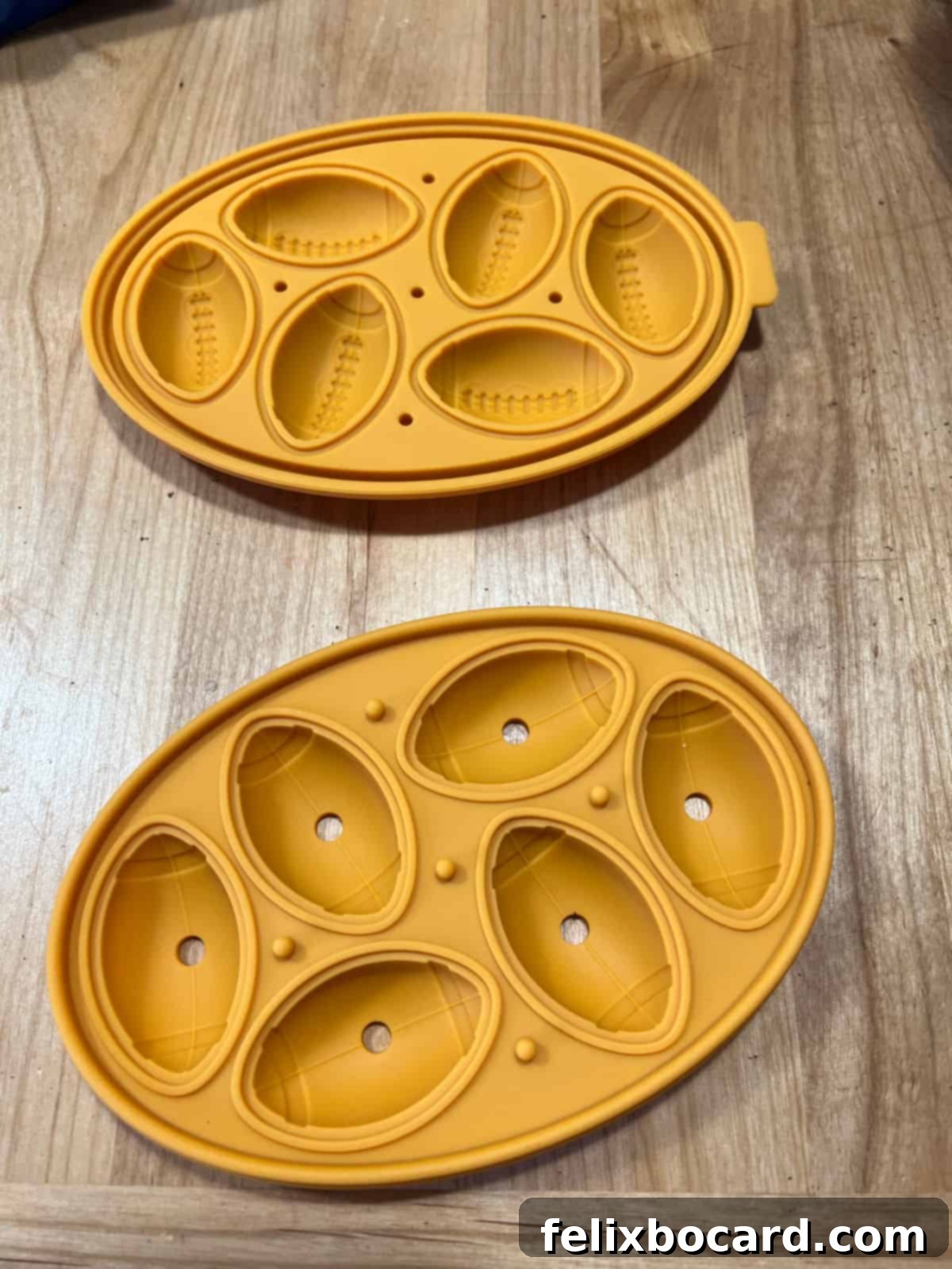 Close-up of football-shaped silicone molds, ready to be filled with the Oreo truffle mixture.