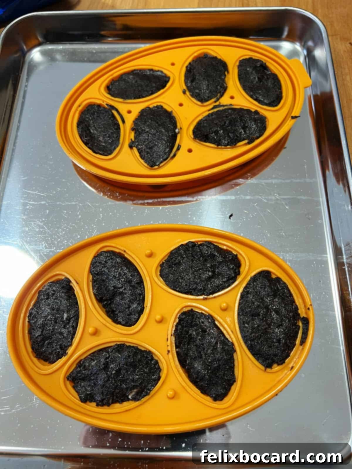 Football silicone molds filled precisely with the creamy Oreo truffle mixture.