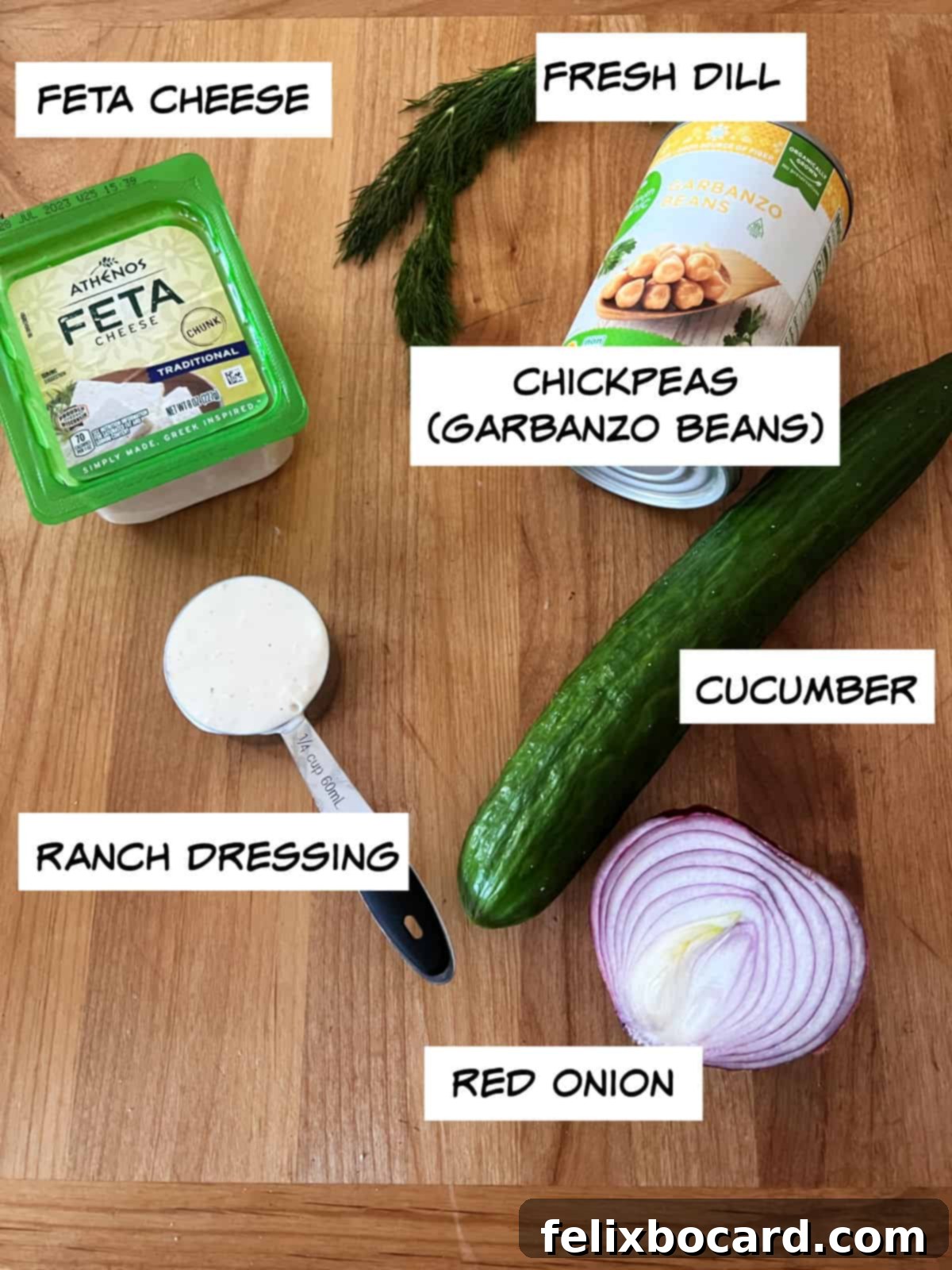 Ingredients for cucumber chickpea salad: feta cheese, chickpeas, cucumber, red onion, ranch dressing.