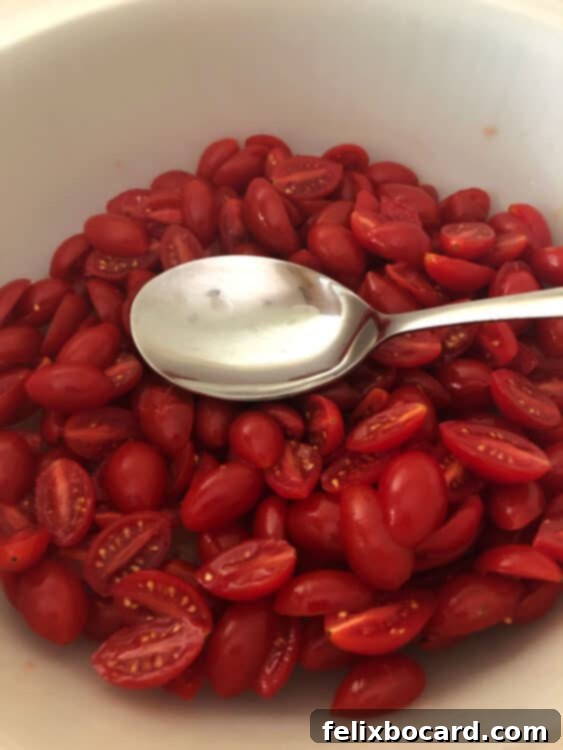 spoon squeezing juice from tomatoes