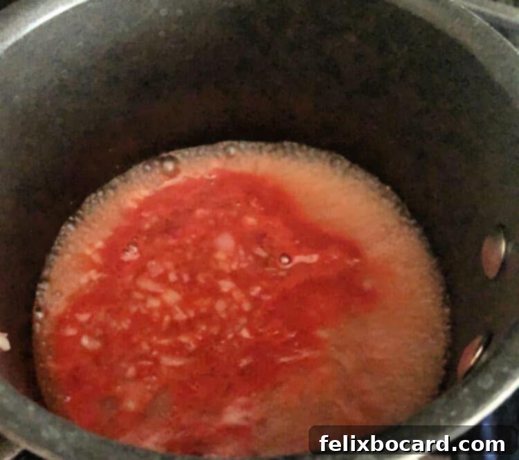boiling red liquid in  small saucepan
