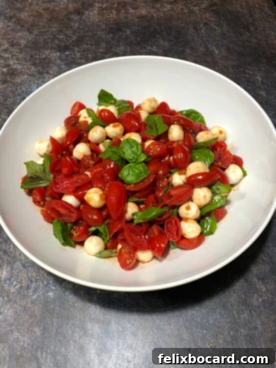 grape tomato mozzarella salad, top down image in a white bowl