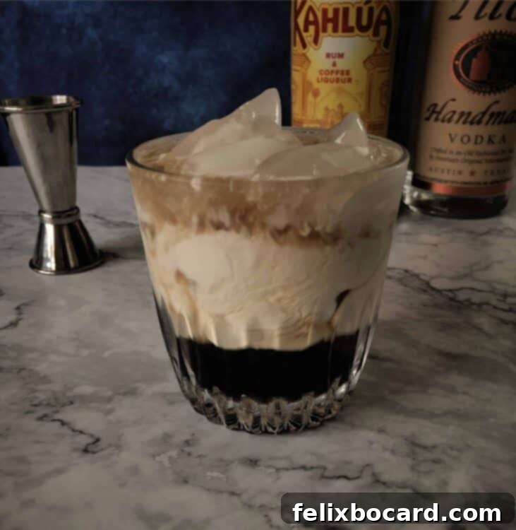 Velvet Vodka Dream 2 A perfectly mixed White Russian cocktail in an Old Fashioned glass with ice, garnished with coffee beans.