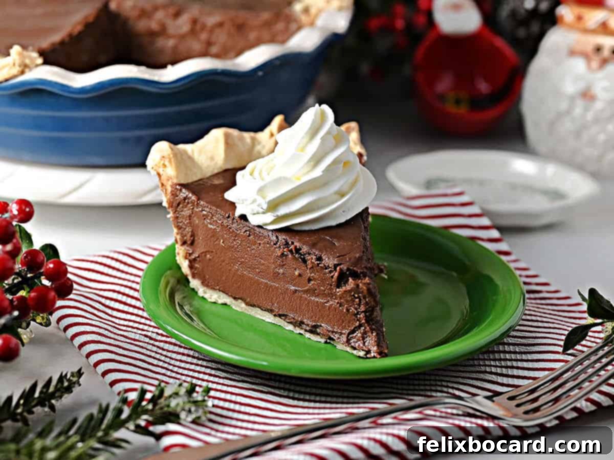 No Bake Chocolate Pie with whipped cream, ready to be served on a pristine white plate.