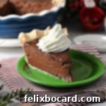 A slice of chocolate pie garnished with whipped cream.