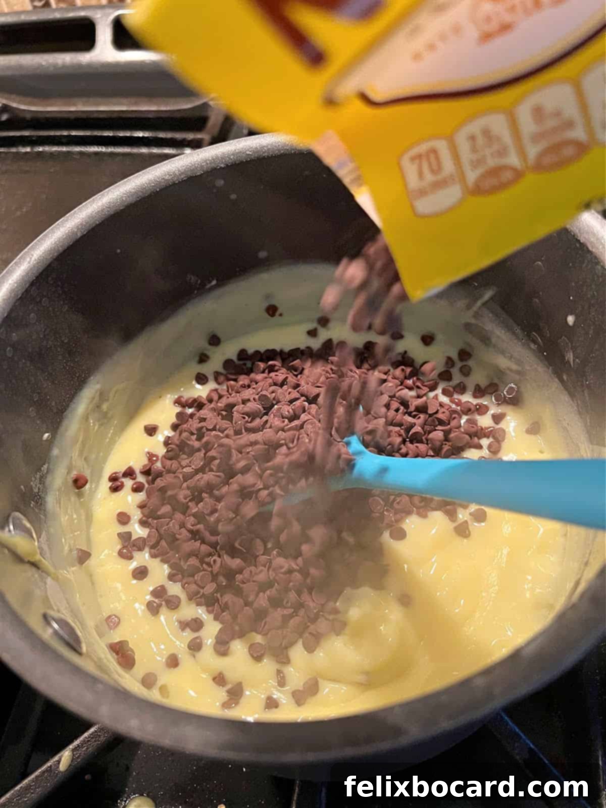 Adding mini chocolate chips to the hot saucepan with the chocolate pie filling, stirring to melt.