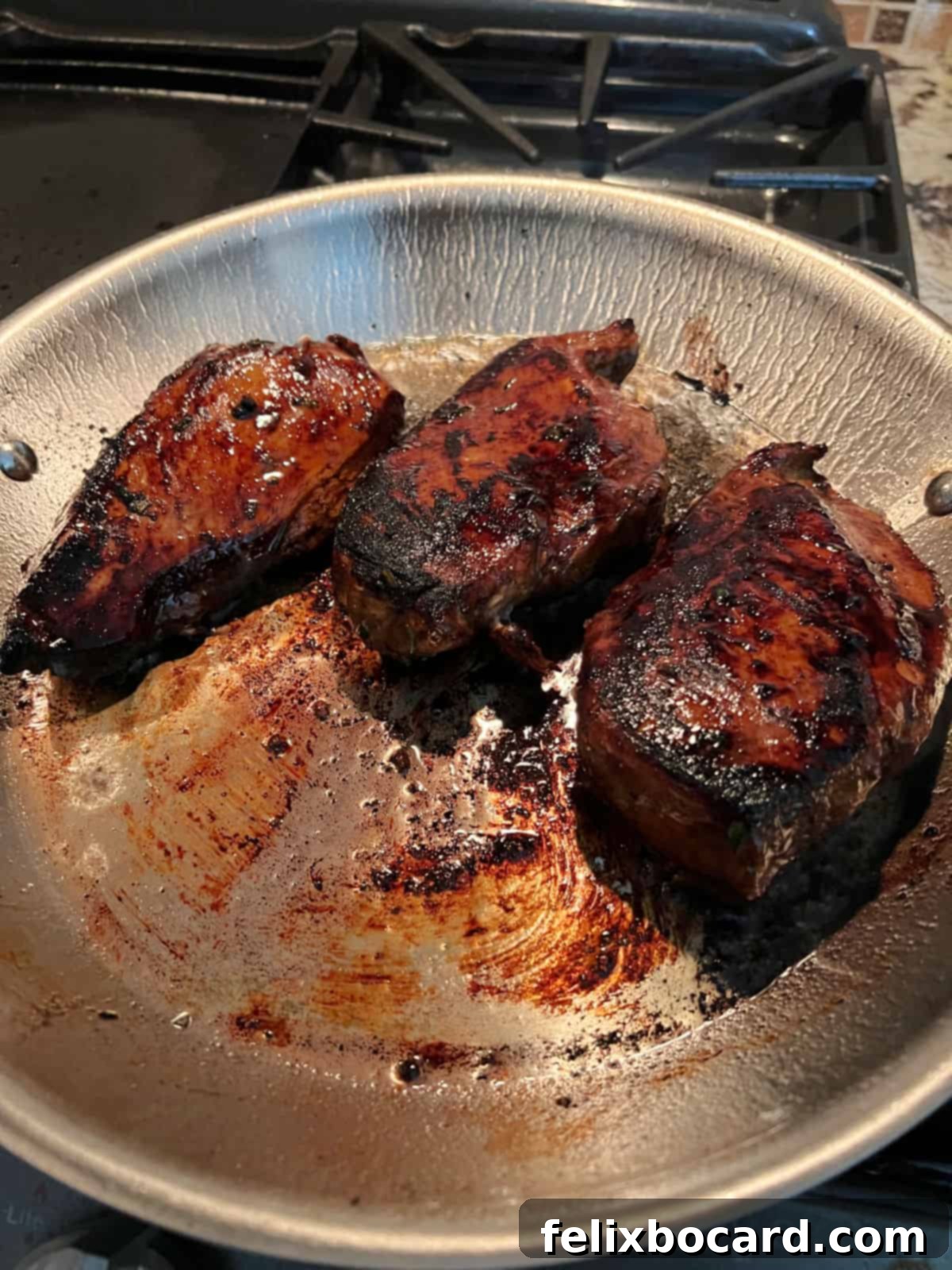 3 cooked chicken breasts in the skillet.