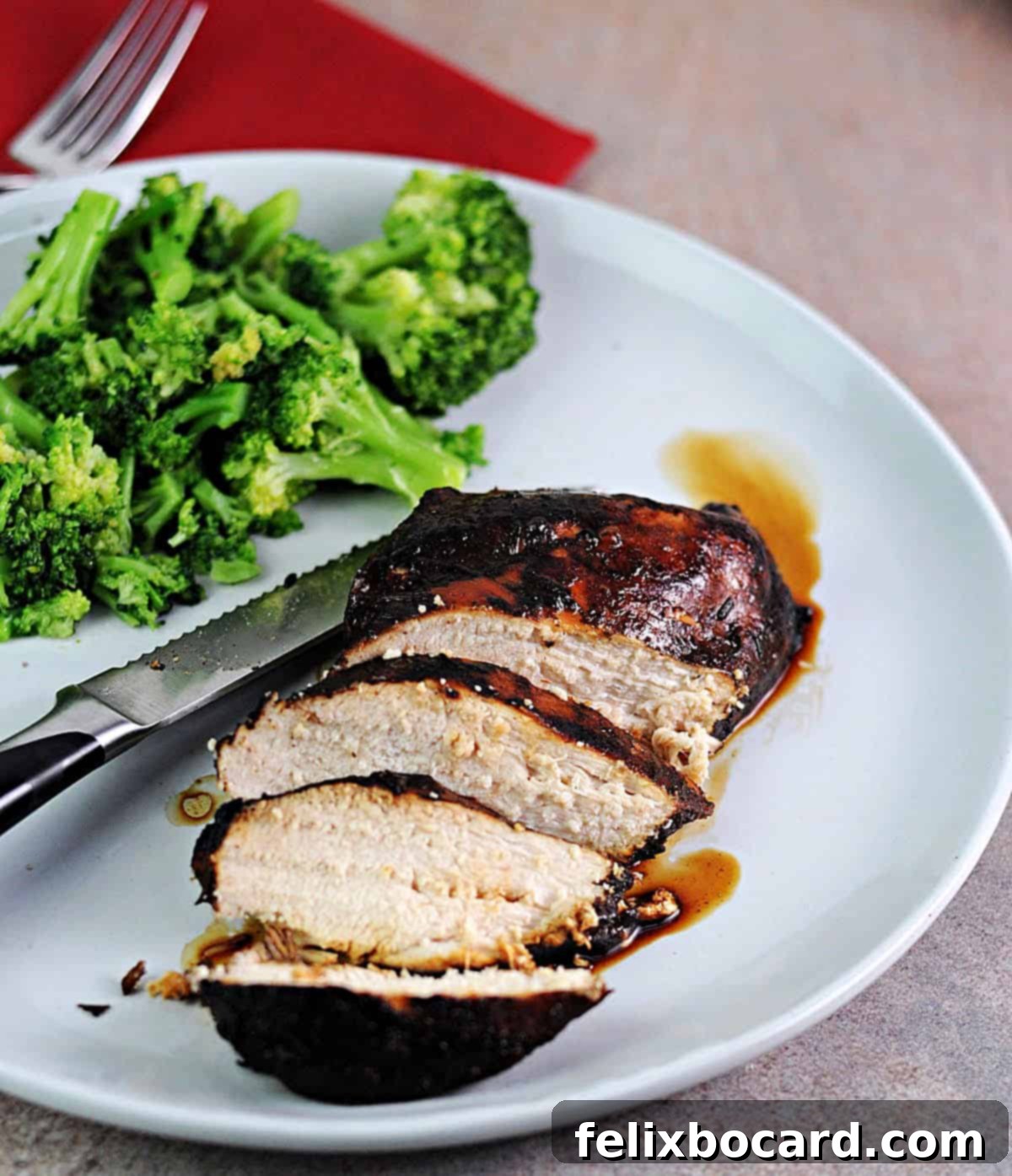 sliced balsamic chicken served with broccoli.