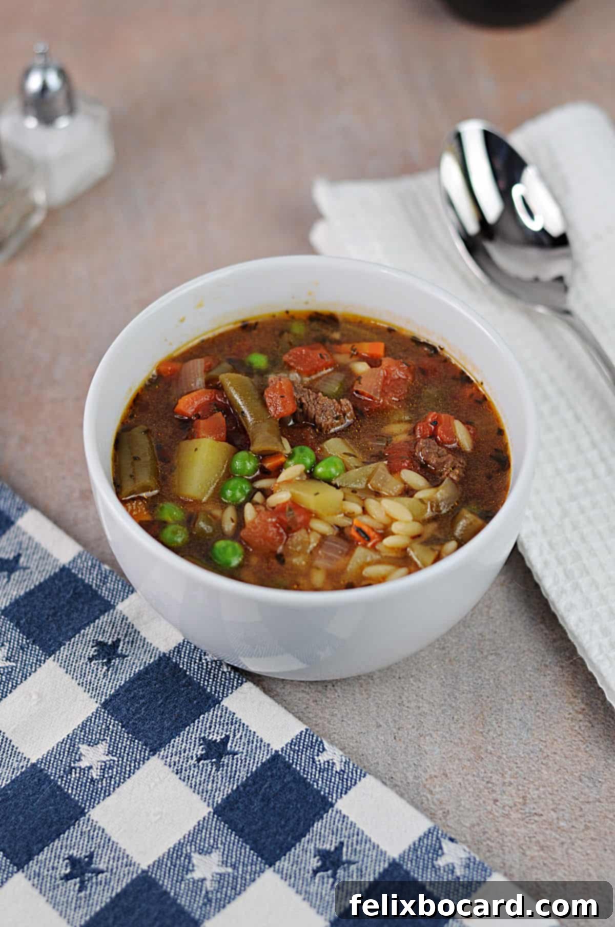 Effortless Instant Pot Beef & Vegetable Soup 2 Small bowl of Instant Pot vegetable beef soup, garnished with fresh herbs.