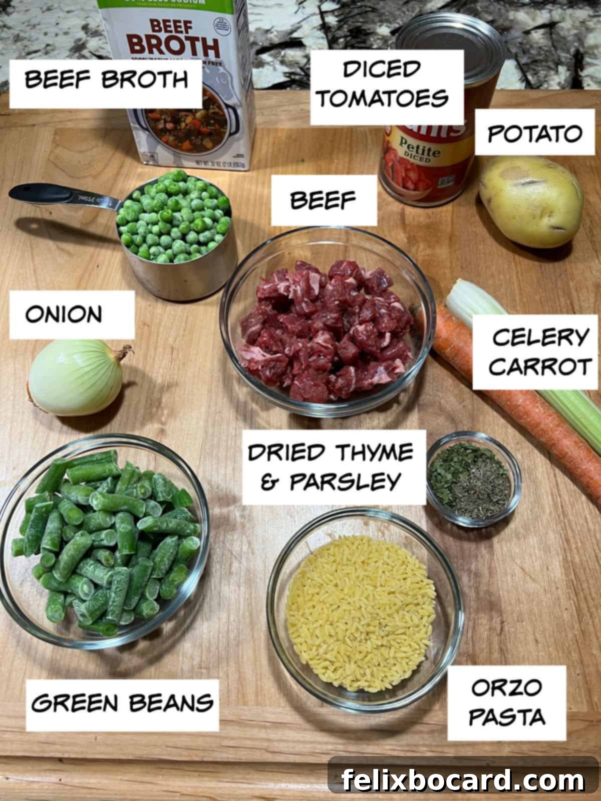 Effortless Instant Pot Beef & Vegetable Soup 3 Ingredients for Instant Pot vegetable beef soup: beef broth, diced tomatoes, potato, beef cubes, onion, celery, carrot, green beans, orzo, thyme, and parsley arranged on a surface.
