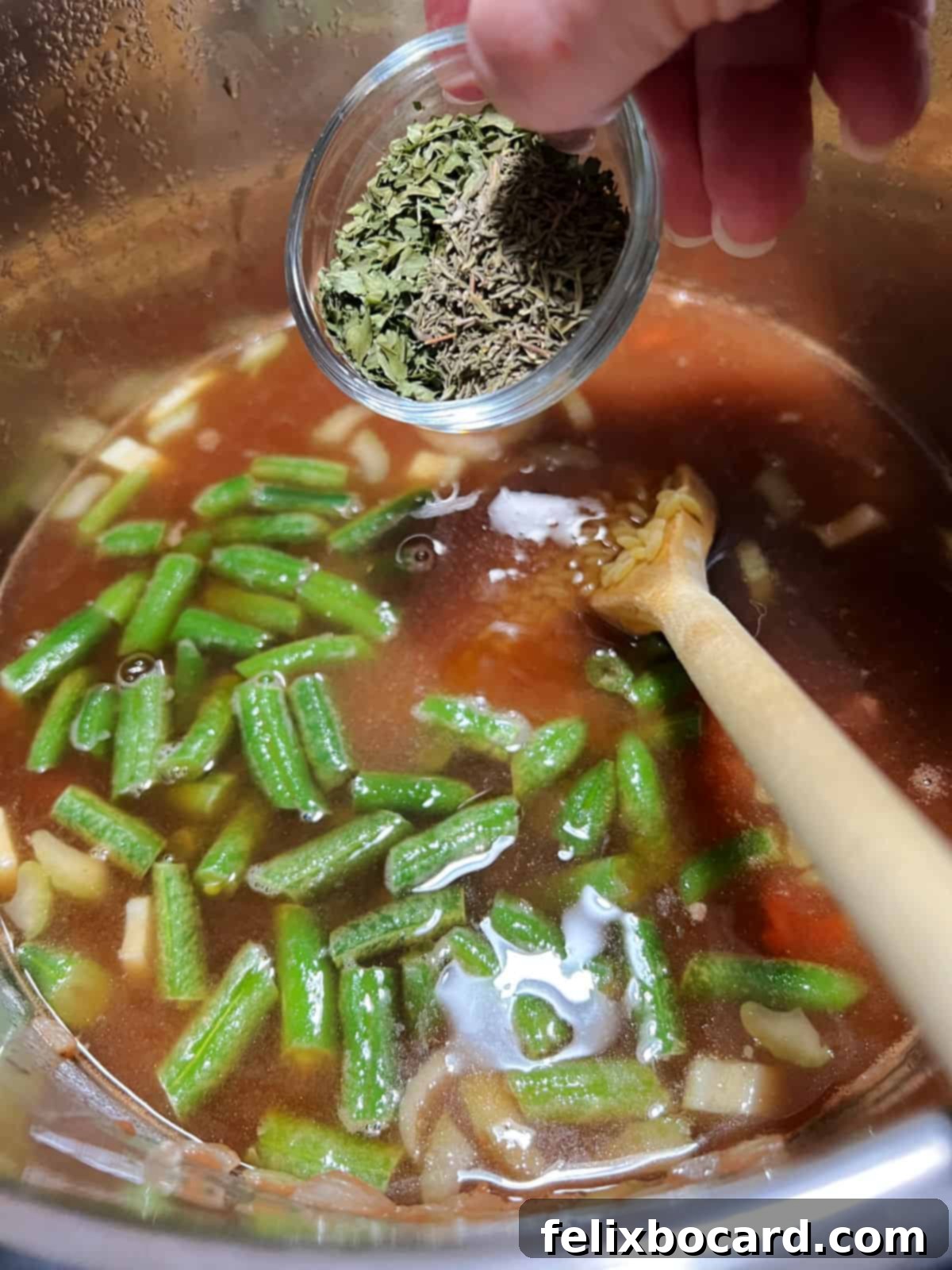 Effortless Instant Pot Beef & Vegetable Soup 6 Adding various chopped vegetables and broth to the Instant Pot after browning the beef.