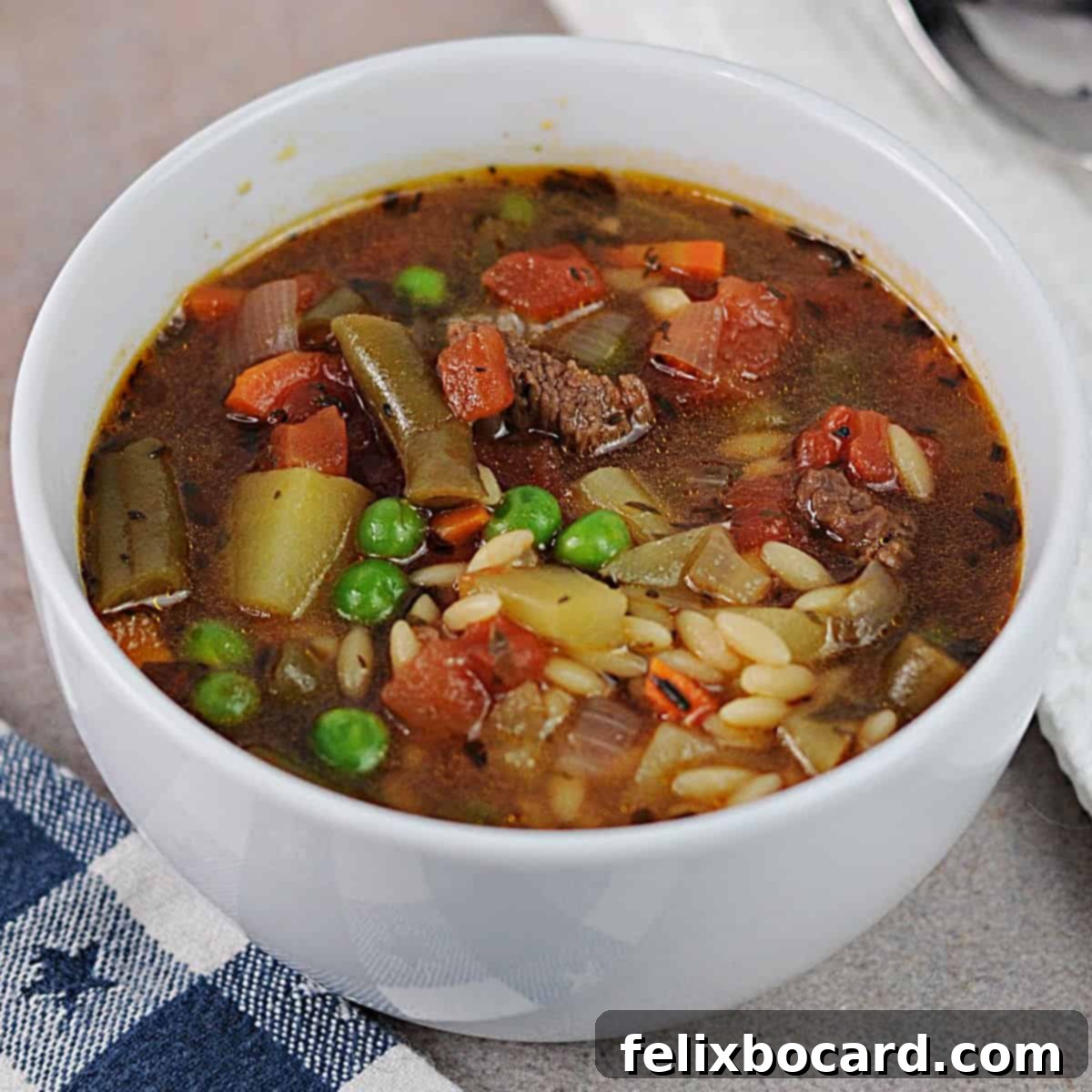 Effortless Instant Pot Beef & Vegetable Soup 9 Close-up of a full bowl of vegetable beef soup made in the Instant Pot, with steam rising.