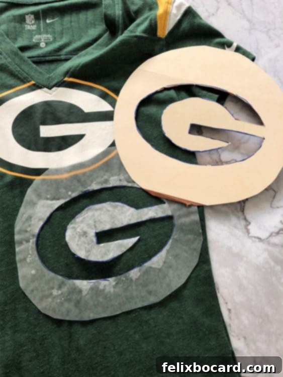 A Green Bay Packers 'G' logo traced onto wax paper, then transferred to a sturdy Manila file folder, used as a stencil for decorating the taco dip.