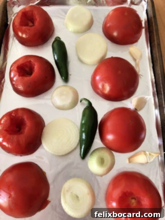 uncooked vegetables on a sheet pan for roasting salsa