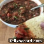 roasted salsa on a chip, bowl in background