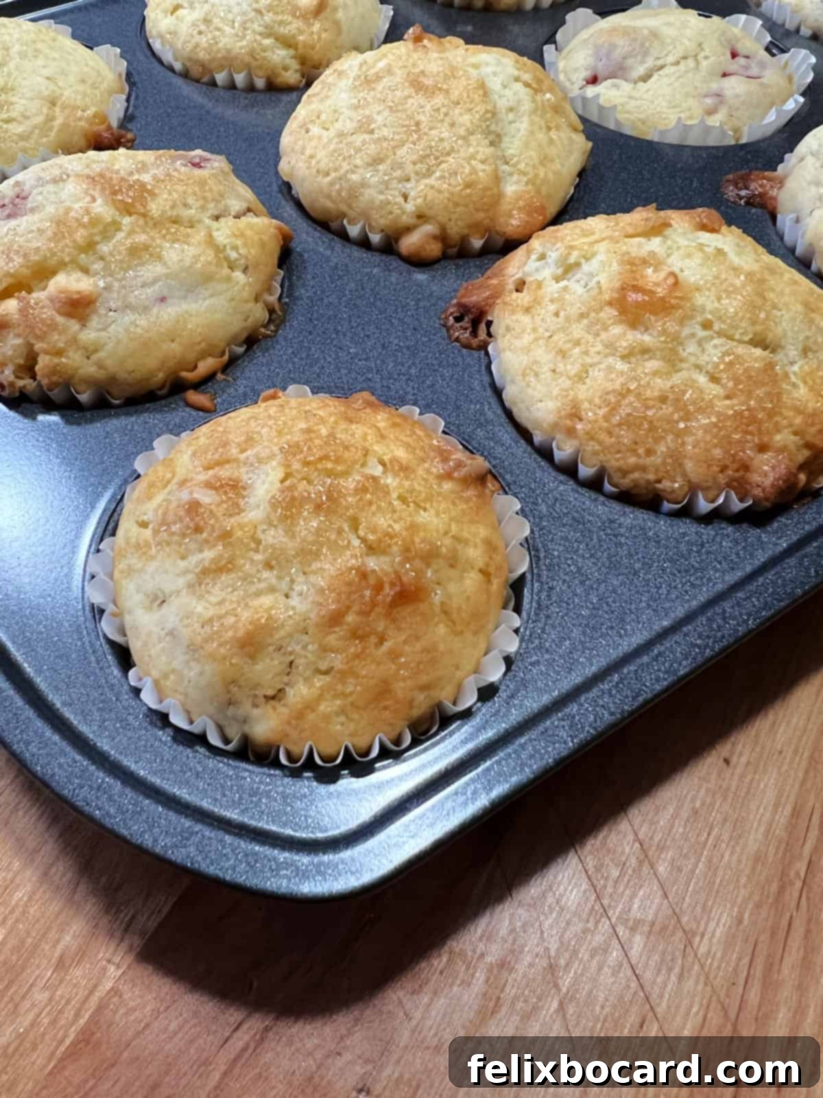 Close-up of a muffin top with a beautiful golden-brown sugar crust, showing the sparkling turbinado sugar.