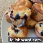 Pancake mix blueberry muffins on a serving tray, showing their golden tops and delicious fruit.