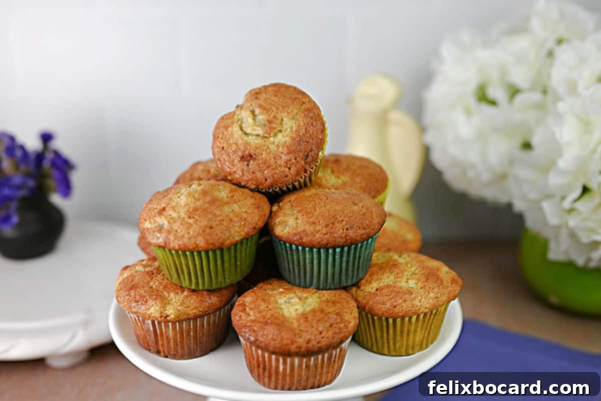 A stack of golden-brown banana bread muffins, perfectly baked and ready to enjoy, artfully arranged on a serving plate.