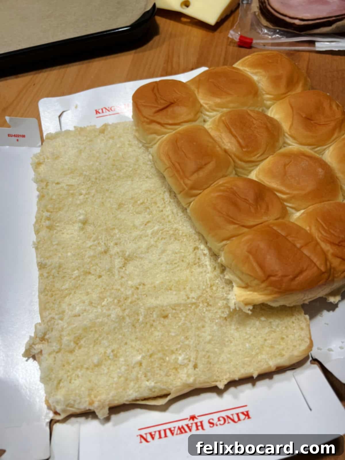 Hawaiian Ham and Cheese Sliders 4 An entire pack of sweet dinner rolls sliced horizontally into two main layers, ready for filling.