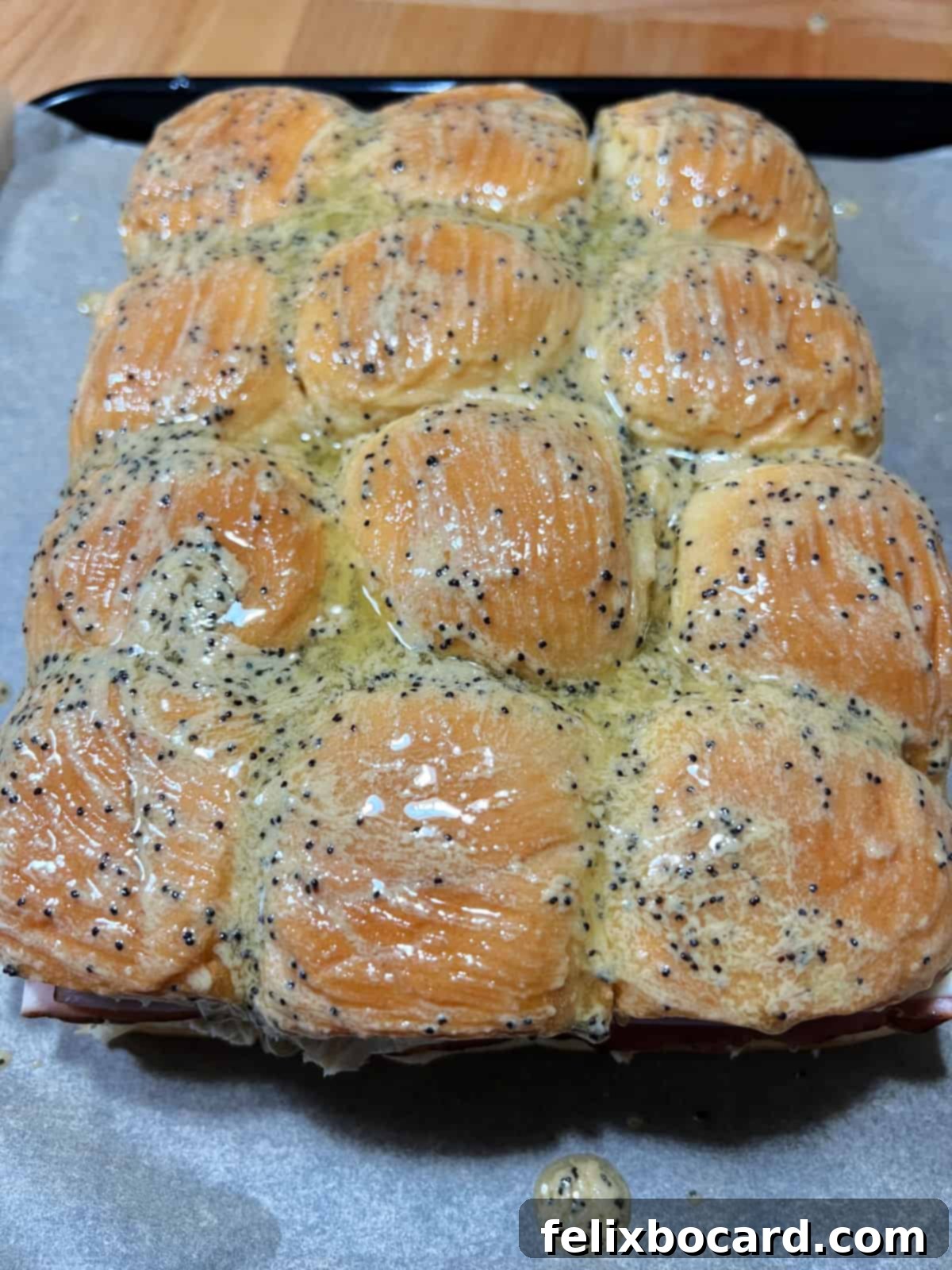 Hawaiian Ham and Cheese Sliders 6 The assembled ham and cheese sliders, with the top buns generously brushed with the savory buttery glaze mixture.