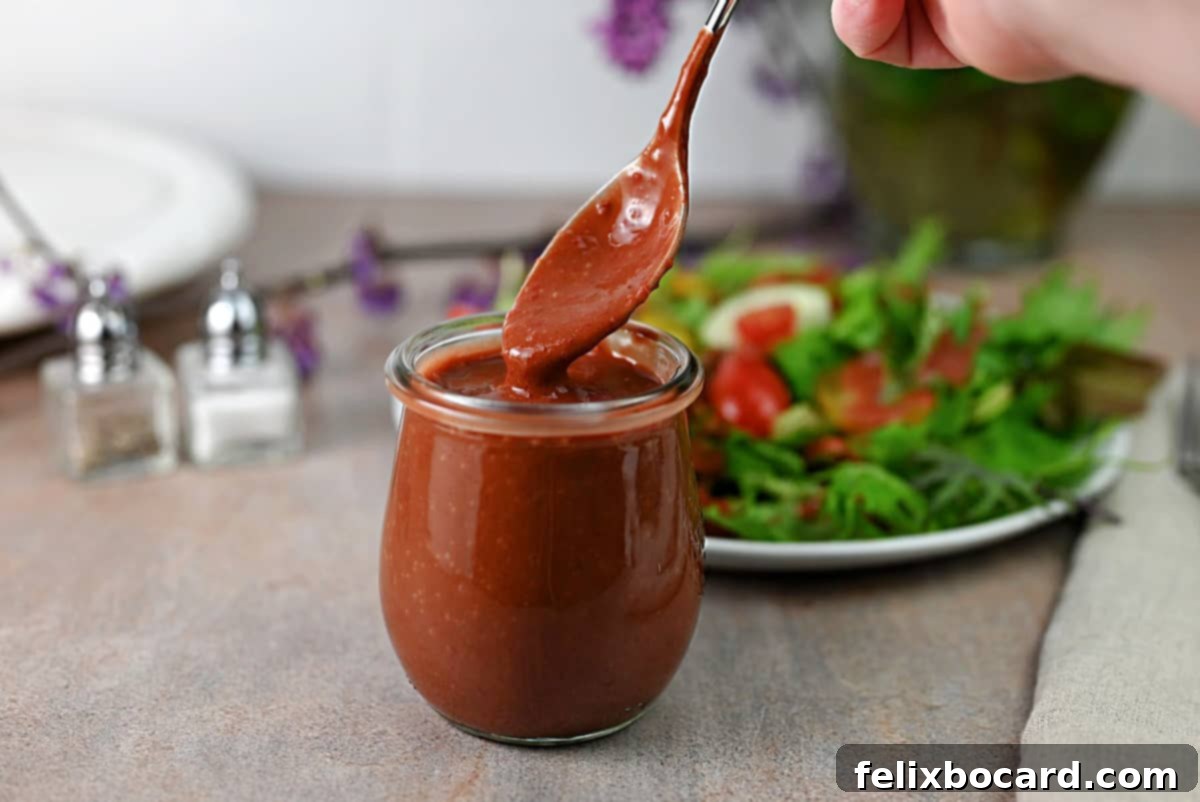 A small jar of strawberry vinaigrette dressing.