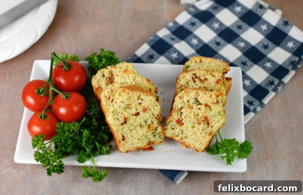 Savory Sun Dried Tomato Quick Bread 2 Slices of golden sun-dried tomato bread on a rustic wooden serving platter, garnished with fresh parsley.