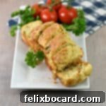 Savory Sun Dried Tomato Quick Bread 11 A sliced mini loaf of sun-dried tomato bread on a serving platter, perfect for sharing.