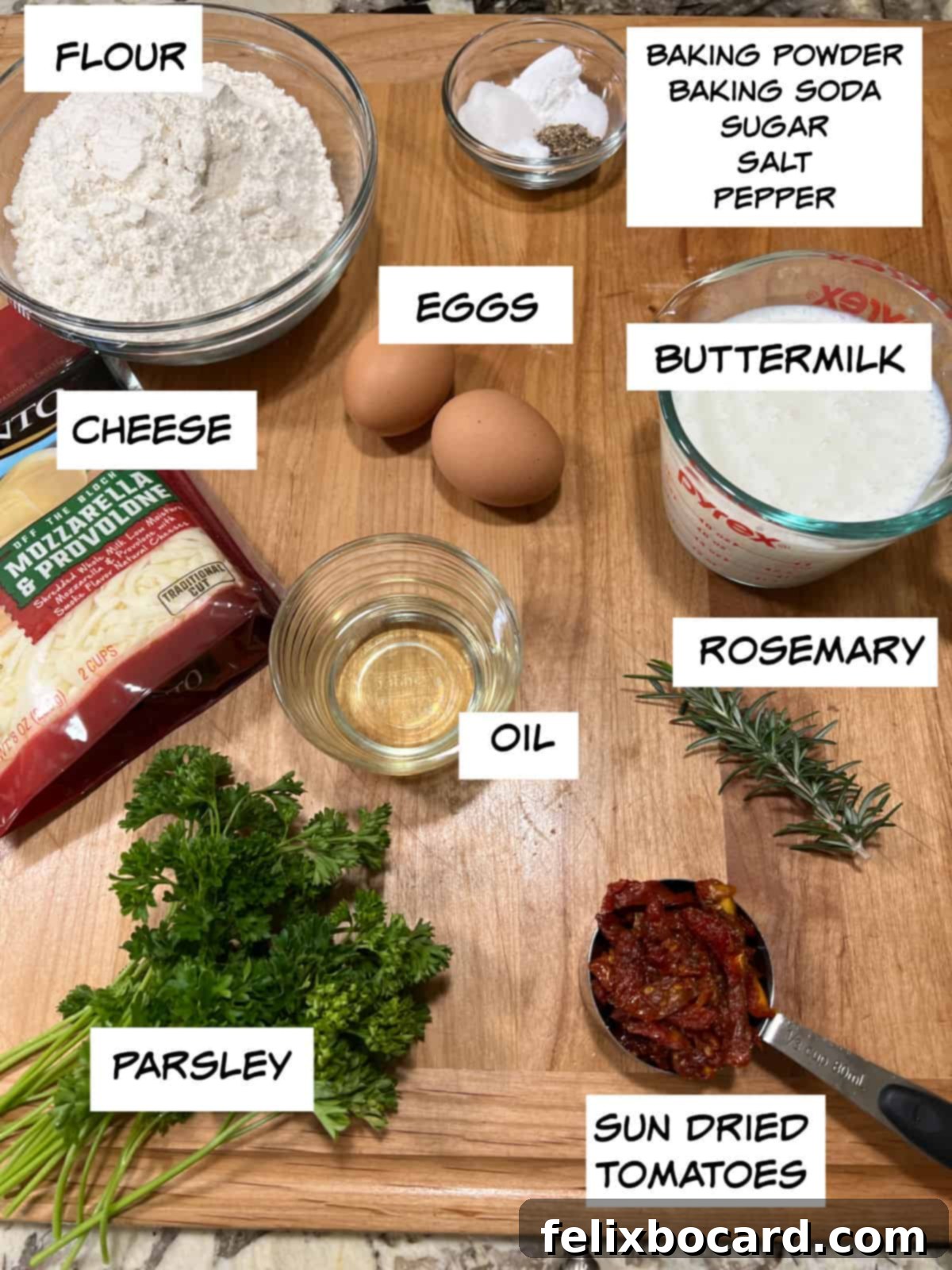 Savory Sun Dried Tomato Quick Bread 3 Assortment of fresh ingredients for sun-dried tomato bread including flour, baking powder, baking soda, salt, pepper, sugar, eggs, buttermilk, shredded cheese, canola oil, fresh rosemary, fresh parsley, and oil-packed sun-dried tomatoes.