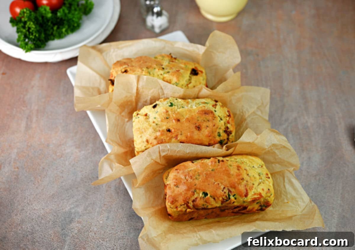 Savory Sun Dried Tomato Quick Bread 8 Three perfectly baked mini loaves of sun-dried tomato bread cooling on a wire rack.