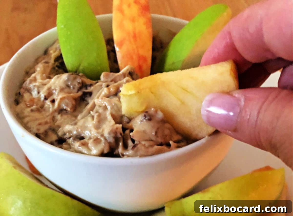dipping an apple slice into the heath bar dip.