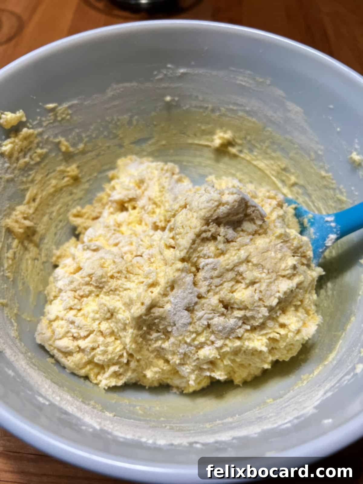 Muffin batter with dry ingredients just folded in, showing a slightly lumpy but well-incorporated texture, ready for cranberries.