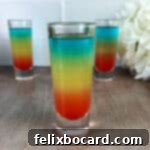 Rainbow shots ready to serve, with distinct blue, yellow, and red layers.