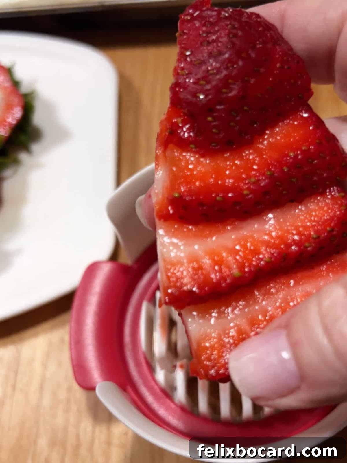 Neatly sliced strawberries, ready for arrangement.