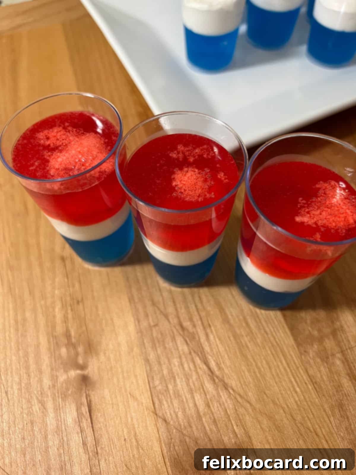 Top view showing the bits of Cool Whip floating in a glass, indicating the red liquid was too warm.