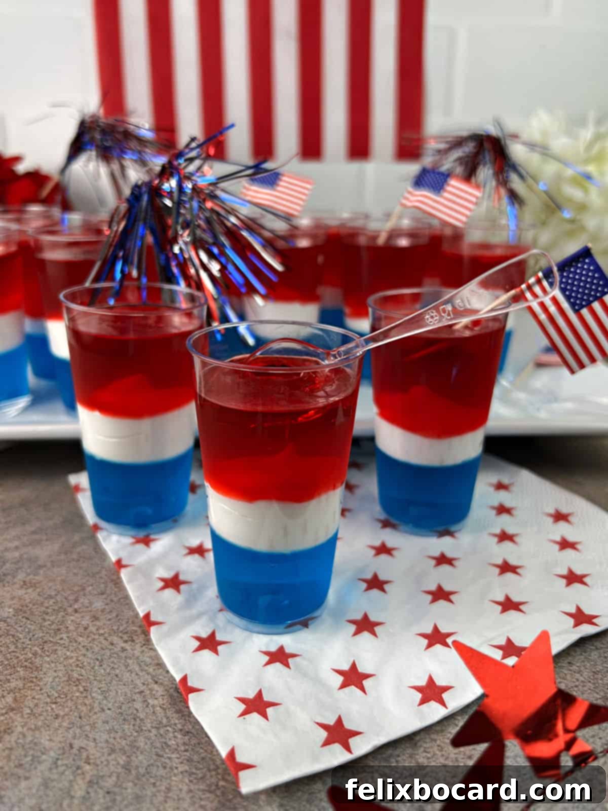 Red White & Blue Jello Shots ready to serve on a white tray.