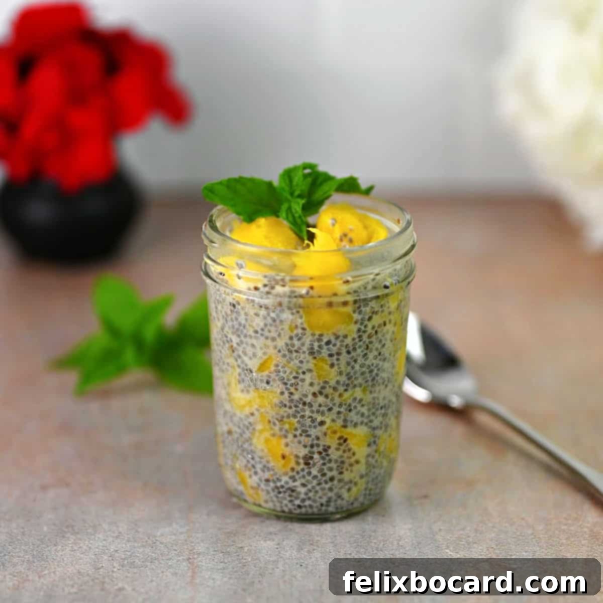A small jar filled with vibrant yellow mango chia seed pudding, ready to be enjoyed as a tropical breakfast or healthy dessert.