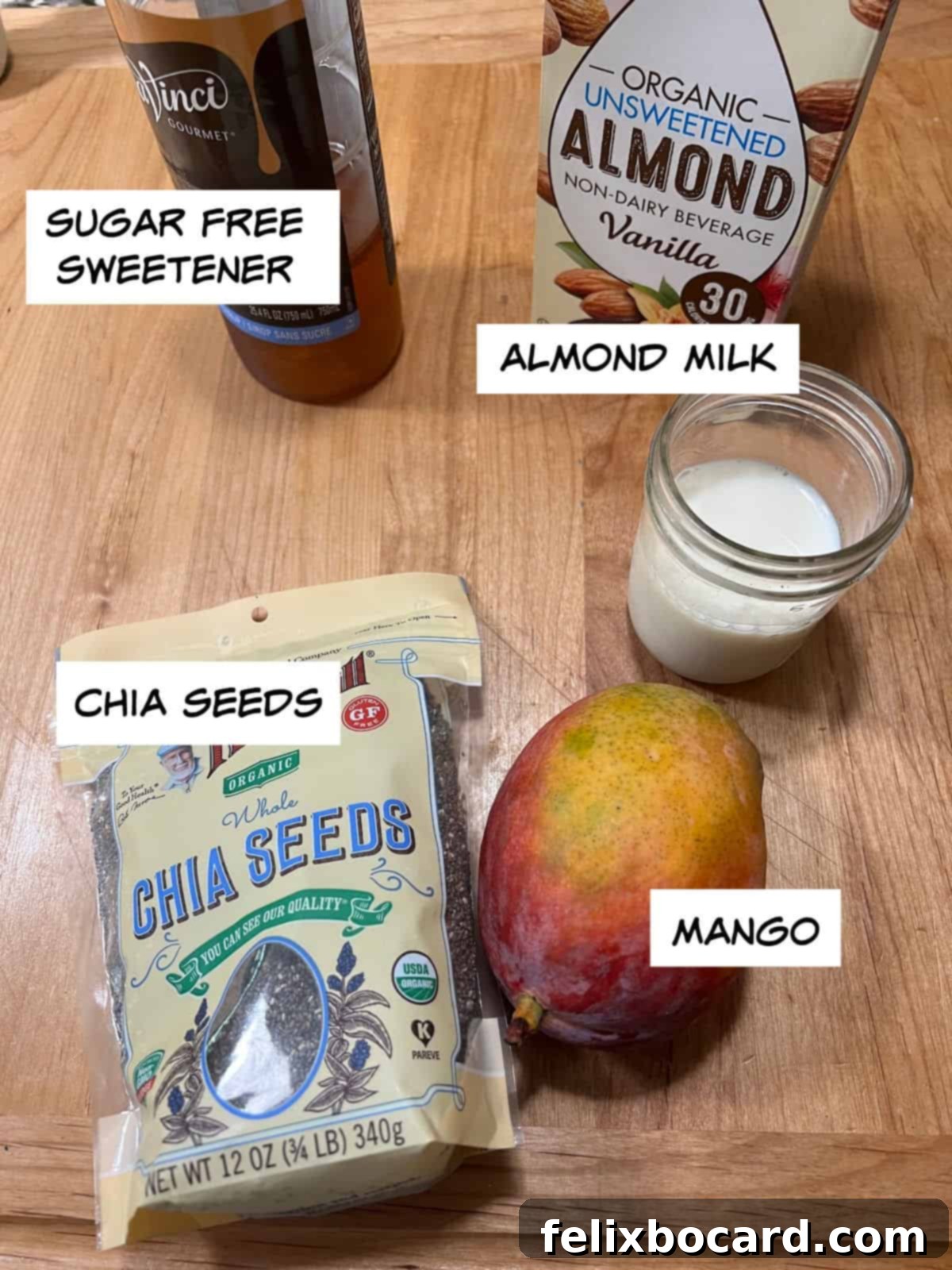 Ingredients for mango chia seed pudding: chia seeds, fresh mango, almond milk, and a sweetener in separate bowls.