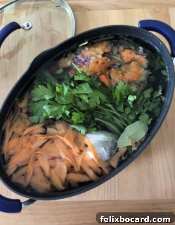 Assorted vegetable scraps and bay leaves in a slow cooker, ready for making homemade broth.