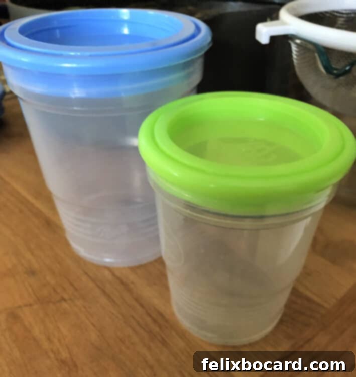 Stack of freezer-safe plastic jars, ideal for storing homemade vegetable broth.