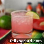 Blushing Grapefruit Margarita 10 A salt rimmed glass filled with pink grapefruit margarita.