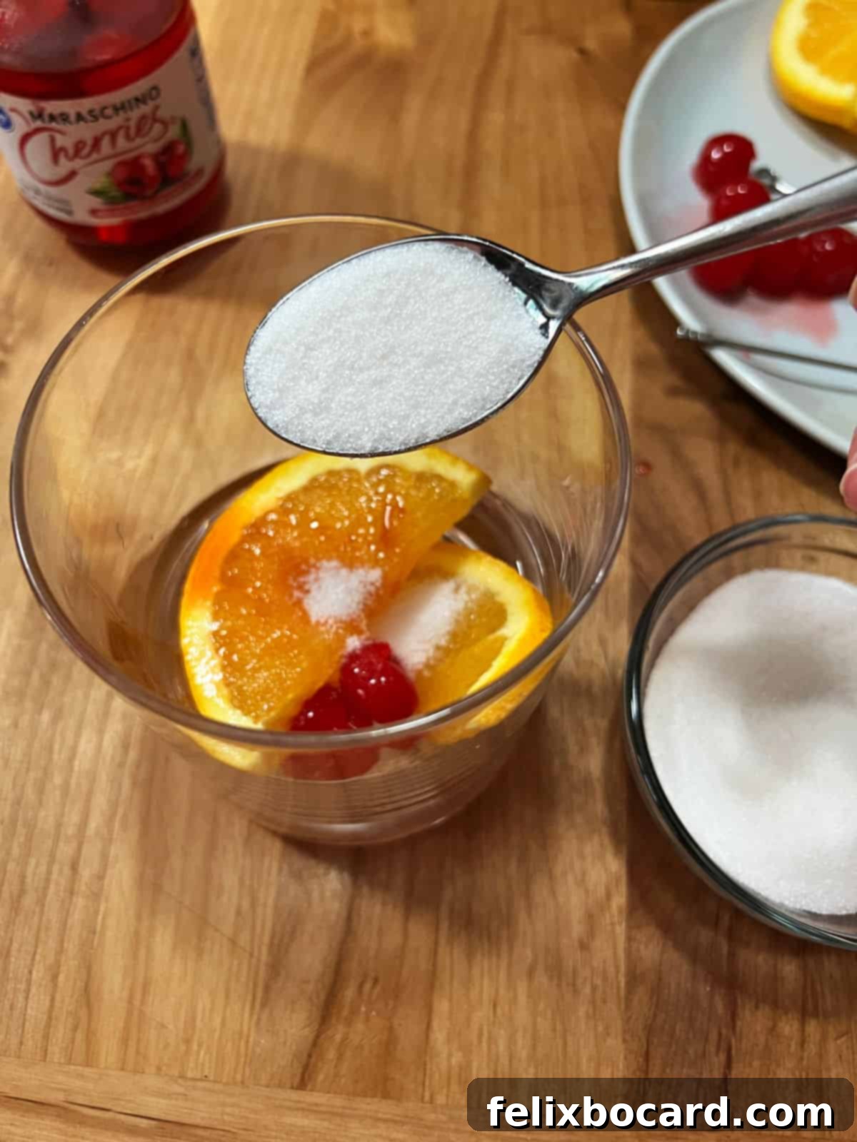 Sweet Wisconsin Brandy Old Fashioned 4 Adding a teaspoon of sugar to the fruit in the glass for a Wisconsin Brandy Old Fashioned.