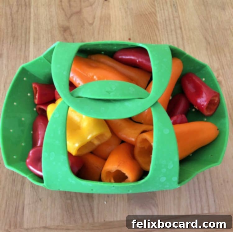 mini peppers in agreen steamer basket, closed and ready to cook