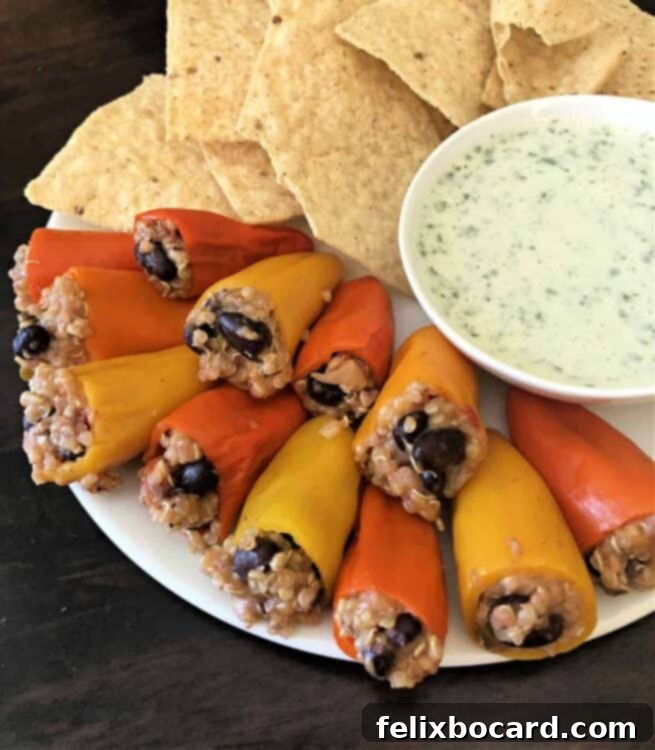 stuffed mini pepper poppers on a plate with chips and sauce