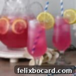 Desert Rose Lemonade 11 Two glasses of prickly pear lemonade garnished with a slice of lemon.