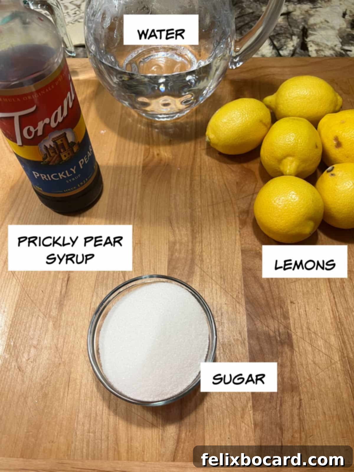 Desert Rose Lemonade 3 Ingredients for prickly pear lemonade: fresh lemons, granulated sugar, water, and a bottle of prickly pear syrup.