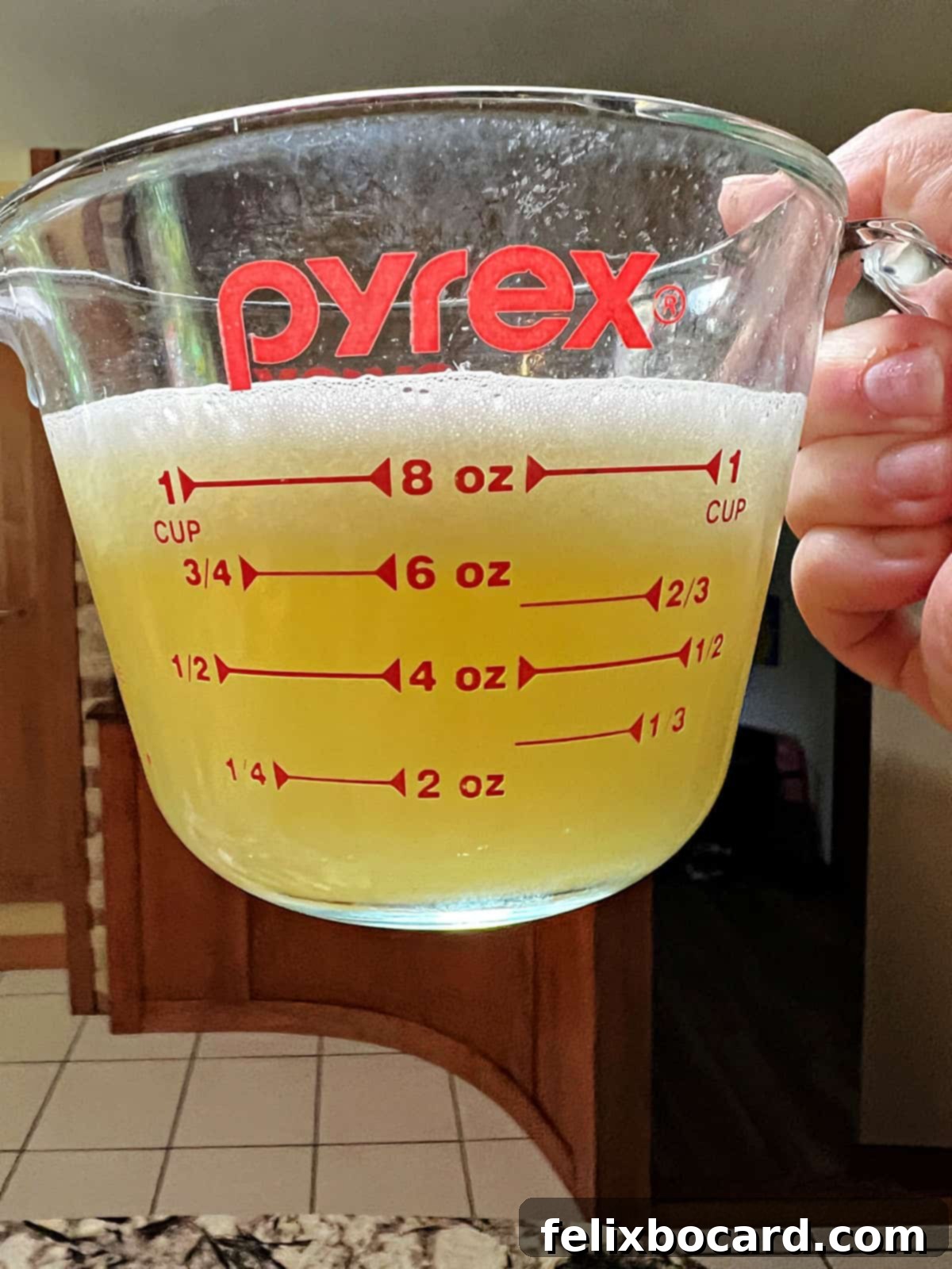 Desert Rose Lemonade 6 A measuring cup filled with fresh squeezed lemon juice, indicating the ¾ cup mark.