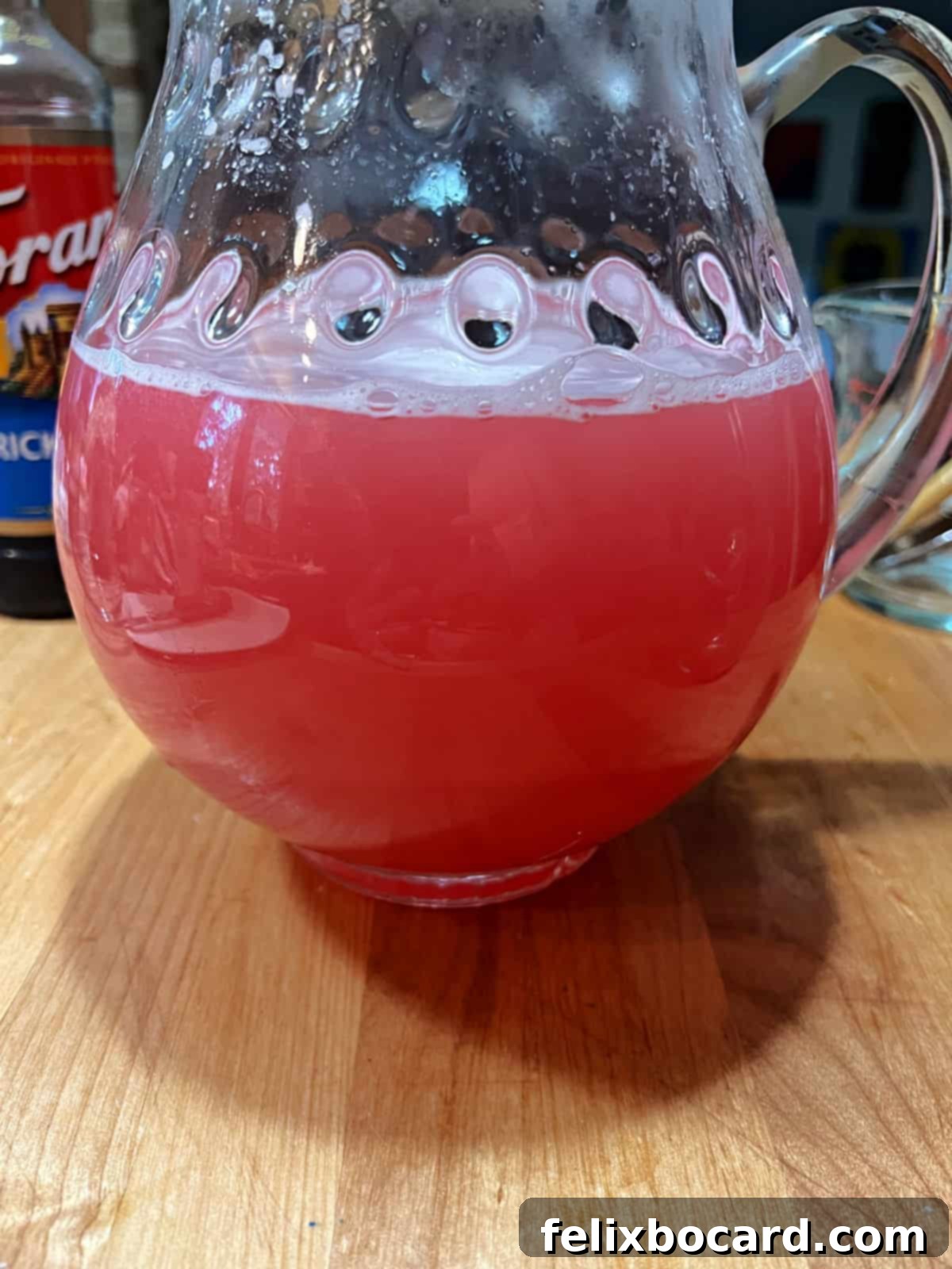 Desert Rose Lemonade 8 A pitcher of fully mixed prickly pear lemonade, showcasing its vibrant pink color.