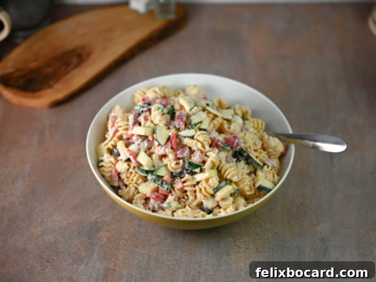 Serving bowl full of salami pasta salad.