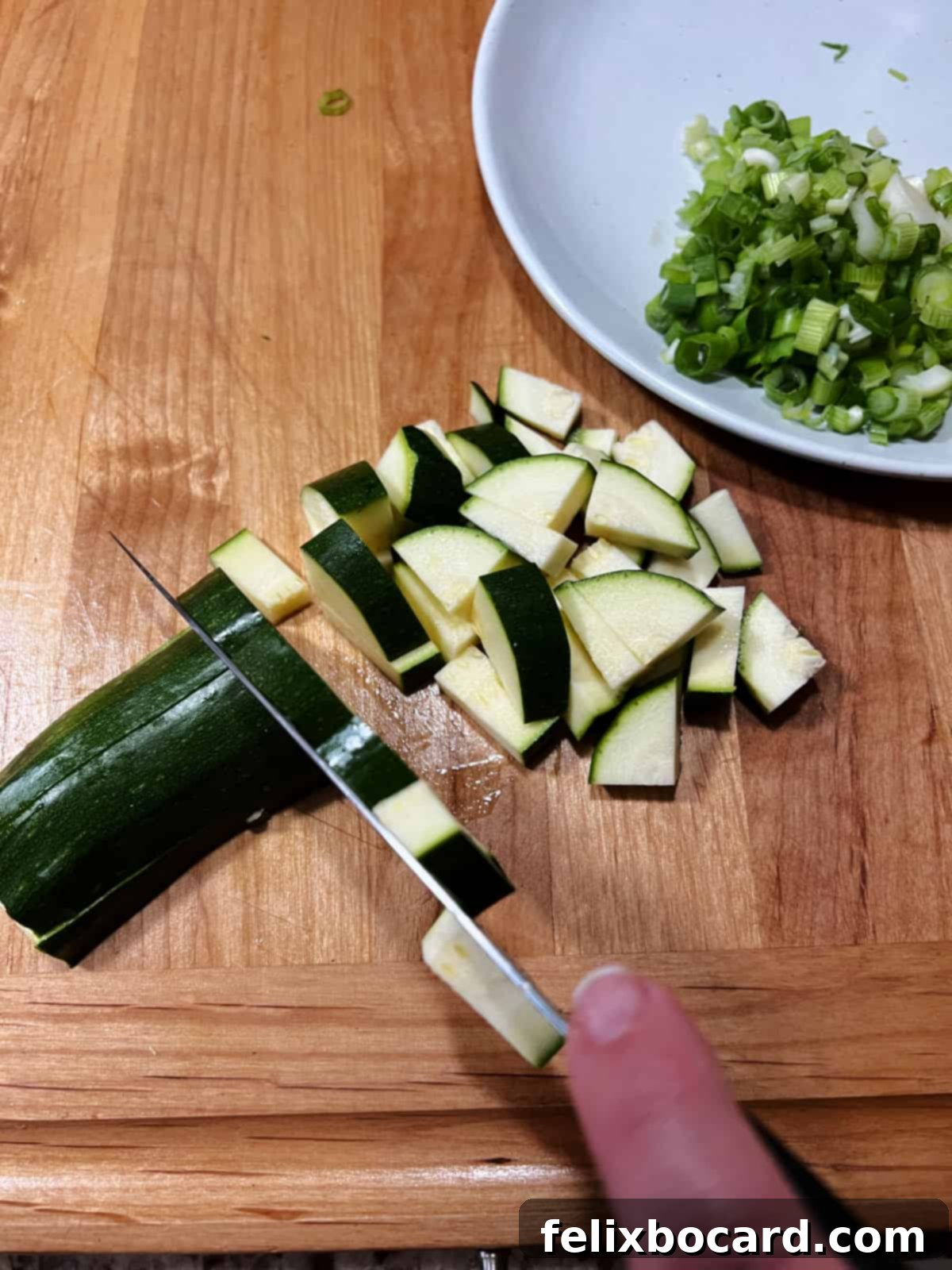 Chopping zucchini.
