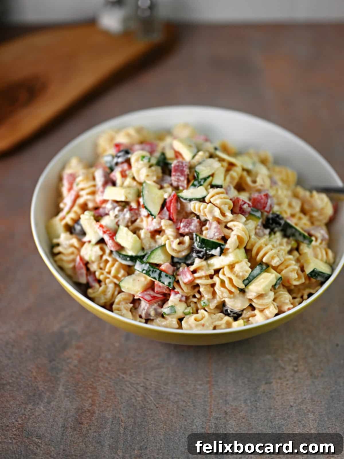 Serving bowl of Italian salami pasta salad.